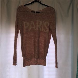 A light pink, knitted sweater